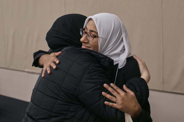 Two women hug as Muslim and Jewish women gather at an interfaith workshop on the Israeli-Palestinian conflict at Rutgers University on Sunday, Nov. 19, 2023, in New Brunswick, N.J. The latest violence, triggered by the Oct. 7 Hamas attack on Israel, is prompting some to question such dialogue, its role, impact -- or how to even have it-- while steeling the resolve of others to connect and wrestle together with the challenges. (AP Photo/Andres Kudacki)