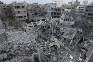 FILE - Palestinians inspect the rubble of the Yassin Mosque destroyed after it was hit by an Israeli airstrike at Shati refugee camp in Gaza City, early Monday, Oct. 9, 2023. (AP Photo/Adel Hana, File)