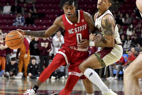 North Carolina State's Terquavion Smith (0) bumps into Boston College's Makai Ashton-Langford (11) during the first half of an NCAA college basketball game, Saturday, Feb. 11, 2023, in Boston. (AP Photo/Mark Stockwell)