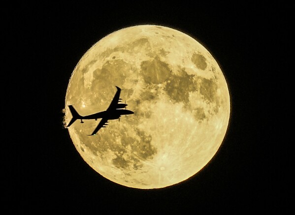 Akıncı unmanned aerial craft passing in front of the Supermoon during a demonstration flight on the first day of Teknofest technology and aerospace festival in Ankara, Turkey, Wednesday, Aug. 30, 2023. (AP Photo/Emrah Gurel)