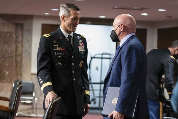 Sen. Mark Kelly, D-Ariz., speaks to Special Operations Command Gen. Richard Clarke after a hearing to examine United States Special Operations Command and United States Cyber Command in review of the Defense Authorization Request for fiscal year 2022 and the Future Years Defense Program, on Capitol Hill, Thursday, March 25, 2021, in Washington. (Anna Moneymaker/The New York Times via AP, Pool)