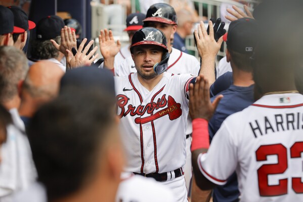 Atlanta Braves' Travis d'Arnaud, center, celebrates with teammates after hitting a two-run home run against the Miami Marlins during the eighth inning of a baseball game Sunday, July 2, 2023, in Atlanta. (AP Photo/Alex Slitz)