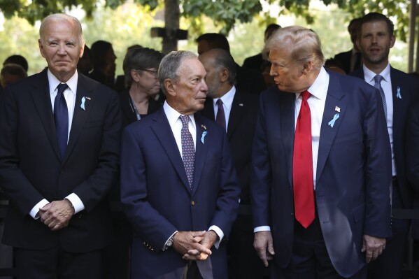 Politics tamfitronics Republican presidential nominee former President Donald Trump, right, talks with Michael Bloomberg, center, as President Joe Biden looks on during the 9/11 Memorial ceremony on the 23rd anniversary of the Sept. 11, 2001 attacks, Wednesday, Sept. 11, 2024, in New York. (AP Photo/Yuki Iwamura)