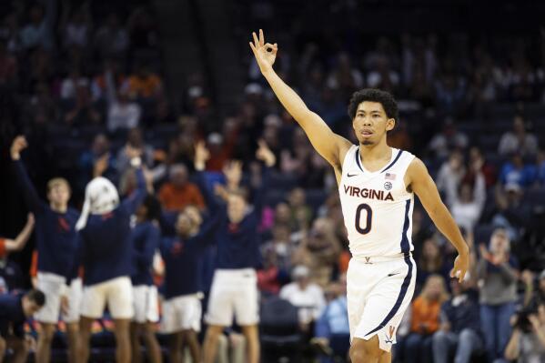 Virginia's Kihei Clark (0) celebrates after a basket against Monmouth during the first half of an NCAA college basketball game in Charlottesville, Va., Friday, Nov. 11, 2022. (AP Photo/Mike Kropf)