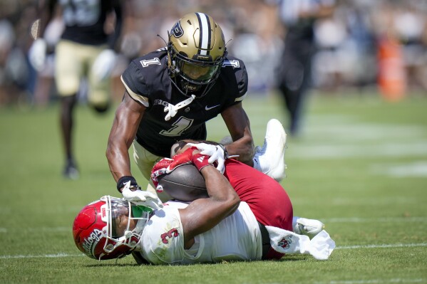 Fresno State wide receiver Erik Brooks (3) goes to the ground with a pass in front of Purdue defensive back Markevious Brown (1) during the second half of an NCAA college football game in West Lafayette, Ind., Saturday, Sept. 2, 2023. Fresno State won 38-35. (AP Photo/AJ Mast)