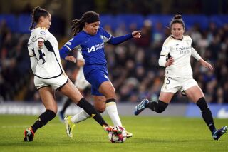 Chelsea's Mia Fishel and Real Madrid's Kathellen Sousa, left, battle for the ball during the UEFA Women's Champions League Group D match at Stamford Bridge, London, Wednesday Jan. 24, 2024. (Zac Goodwin/PA via AP)