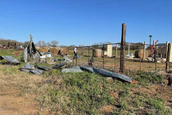 Debris lines the roads as crews and homeowners work to repair properties damaged by severe weather in Elgin, Texas, Tuesday, March 22, 2022.  Officials say multiple tornadoes ripped through parts of Texas and Oklahoma on Monday.  (AP Photo/Acacia Coronado)