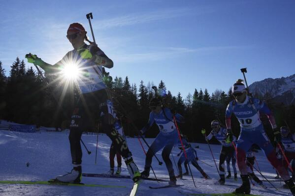 Denise Herrmann of Germany, left, competes during the women's 12.5km mass start race at the biathlon World Cup in Anterselva, Italy, Sunday, Jan. 23, 2022. (AP Photo/Matthias Schrader)