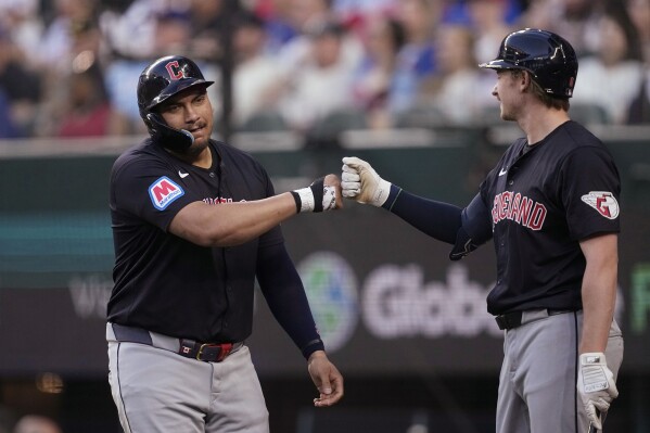CORRECTS TO KYLE MANZARDO, INSTEAD OF DAVID FRY - Cleveland Guardians' Josh Naylor celebrates his three-run home run against the Texas Rangers with Kyle Manzardo, right, during the second inning of a baseball game Tuesday, May 14, 2024, in Arlington, Texas. (AP Photo/Tony Gutierrez)