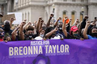 FILE - In this Sept. 25, 2020, file photo, Black Lives Matter protesters march in Louisville. Hours of material in the grand jury proceedings for Taylor’s fatal shooting by police have been made public on Friday, Oct. 2. (AP Photo/Darron Cummings, File)