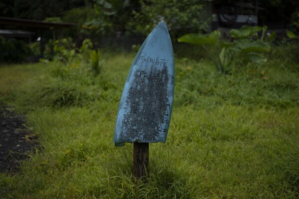 The etching on the broken surfboard reads: "private property" Te Aupo, Tahiti, French Polynesia, Monday, January 15, 2024 (AP Photo/Daniel Cole)