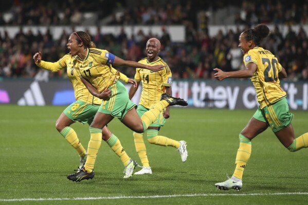 Jamaica's Allyson Swaby, left, celebrates with teammates after scoring the opening goal during the Women's World Cup Group F soccer match between Panama and Jamaica in Perth, Australia, Saturday, July 29, 2023. Jamaica won 1-0. (AP Photo/Gary Day)