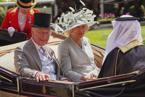 Britain's King Charles and Queen Camilla arrive by carriage into the Parade Ring on the first day of the Royal Ascot horse race meeting at Ascot, England, Tuesday, June 17, 2025. (AP Photo/Alberto Pezzali)