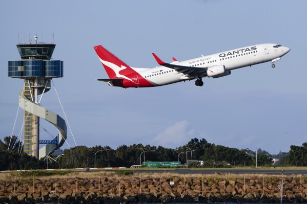 FILE - A Qantas Boeing 737 passenger plane takes off from Sydney Airport, Australia, on Sept. 5, 2022. Qantas Airways agreed to pay 120 million Australian dollars ($79 million) in compensation and fines for selling tickets on thousands of cancelled flights, the airline and Australia’s consumer watchdog said on Monday, May 6, 2024. (AP Photo/Mark Baker, File)