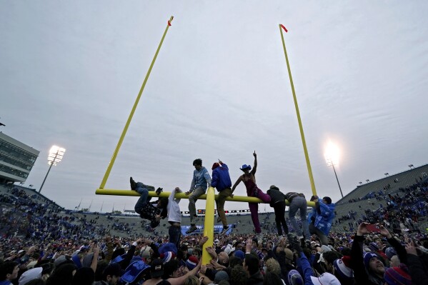 Kansas fans celebrate on the field after their NCAA college football game against Oklahoma Saturday, Oct. 28, 2023, in Lawrence, Kan. Kansas won 38-33. (AP Photo/Charlie Riedel)