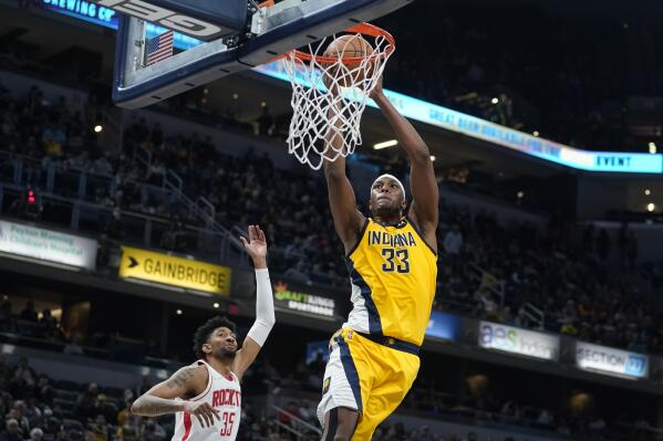 Indiana Pacers' Myles Turner (33) dunks against Houston Rockets' Christian Wood (35) during the second half of an NBA basketball game, Thursday, Dec. 23, 2021, in Indianapolis. (AP Photo/Darron Cummings)