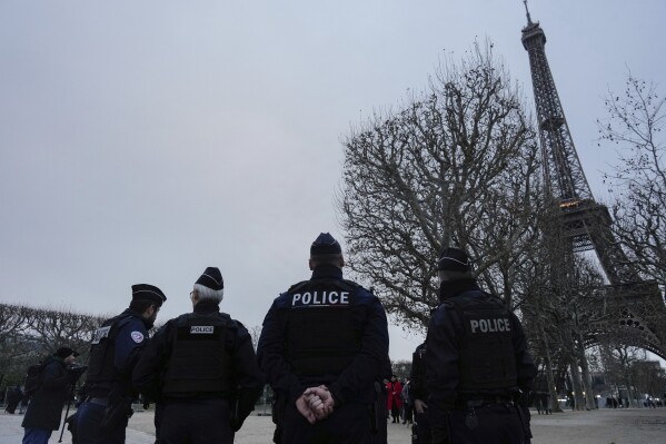 FILE - French policemen patrol around the Eiffel Tower, in Paris, Thursday, Dec. 7, 2023. Paris City Hall said Wednesday Feb. 28, 2024 that no policing plans for the upcoming Olympic Games were lost in the theft of computer gear reported by one of its employees. (APPhoto/Thibault Camus, File)