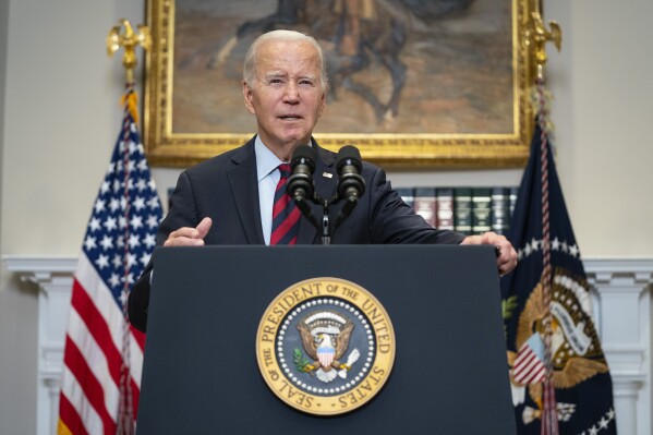FILE - President Joe Biden talks with reporters after delivering remarks on student loan debt forgiveness, in the Roosevelt Room of the White House, Wednesday, Oct. 4, 2023, in Washington. On Friday, Sept. 6, The Associated Press reported on stories circulating online incorrectly claiming The Biden administration is giving people who enter the U.S illegally payments of $2,200 per month. (AP Photo/Evan Vucci, File)