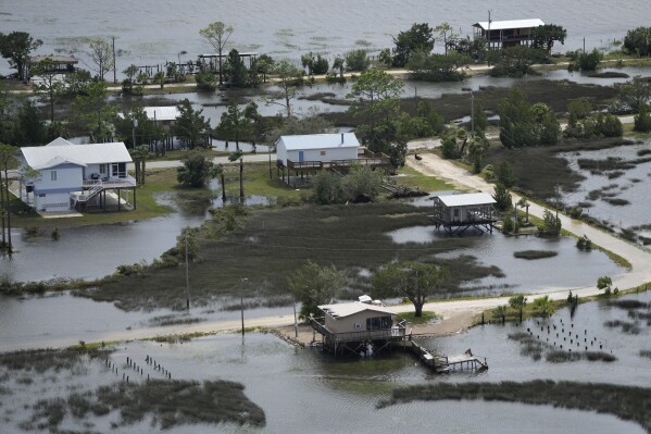 FILE - In this photo made in a flight provided by mediccorps.org, receding storm waters surround homes in Keaton Beach, Fla., following the passage of Hurricane Idalia, Wednesday, Aug. 30, 2023. A handful of powerful tropical storms in the last decade and the prospect of more to come has some experts proposing a new category of hurricanes: Category 6, which would be for storms with wind speeds of 192 miles per hour or more. (AP Photo/Rebecca Blackwell, File)