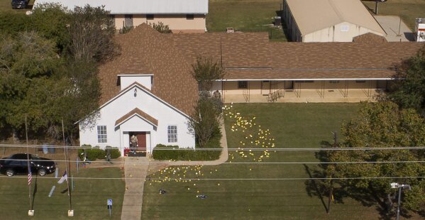 
              Flags mark evidence on the lawn of the First Baptist Church in Sutherland Springs, Texas, Monday, Nov. 6, 2017, a day after over 20 people died in a mass shooting Sunday. (Jay Janner/Austin American-Statesman via AP)
            