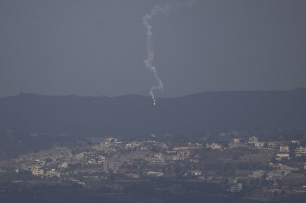 An Israeli army flare is seen over the Israeli-Lebanese border as seen from the Israeli-annexed Golan Heights, Monday, Sept. 16, 2024. (AP Photo/Leo Correa)