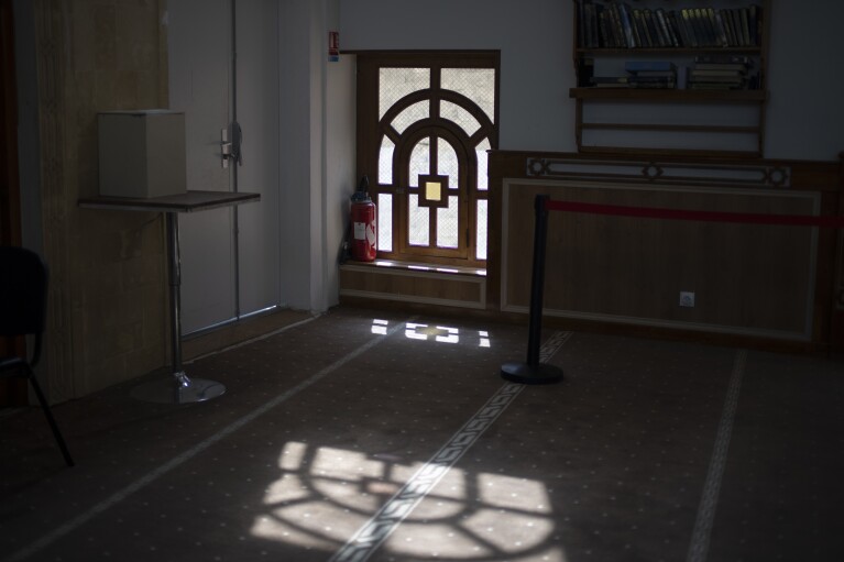 Sunlight shines through a window in the mosque at Ibn Khaldoun, a private Muslim school, in Marseille, southern France, Tuesday, April 16, 2024. (AP Photo/Daniel Cole)