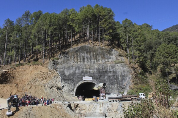 FILE- People watch rescue and relief operations at the site of an under-construction road tunnel that collapsed in mountainous Uttarakhand state, India, Wednesday, Nov. 15, 2023. All 41 construction workers who were trapped have been pulled out after 17 days, on Tuesday, Nov. 28. The efforts to reach the workers, aided by international tunneling experts and spearheaded by multiple Indian rescue agencies, was one of the most significant and complicated rescue operations in India’s recent history. (AP Photo/File)