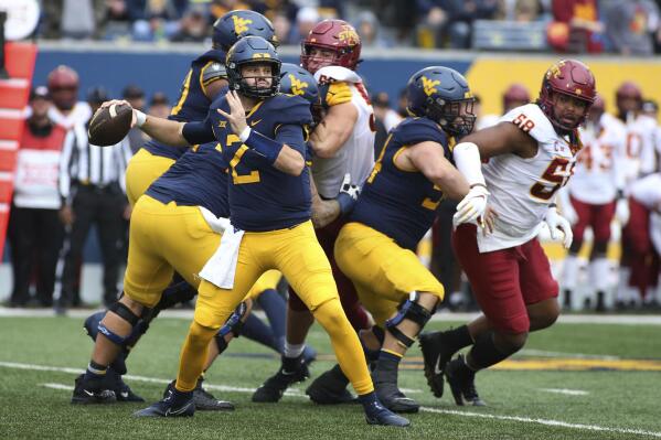 West Virginia quarterback Jarret Doege (2) passes against Iowa State during the first half of an NCAA college football game in Morgantown, W.Va., Saturday, Oct. 30, 2021. (AP Photo/Kathleen Batten)