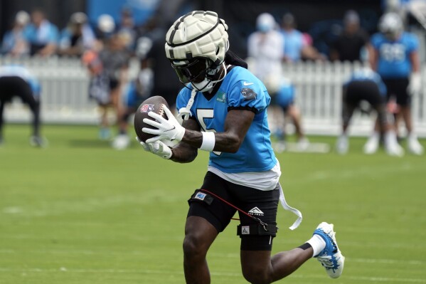 Carolina Panthers wide receiver Diontae Johnson (5) catches a pass during the NFL football team's training camp in Charlotte, N.C., Saturday, Aug. 3, 2024. (AP Photo/Chuck Burton)