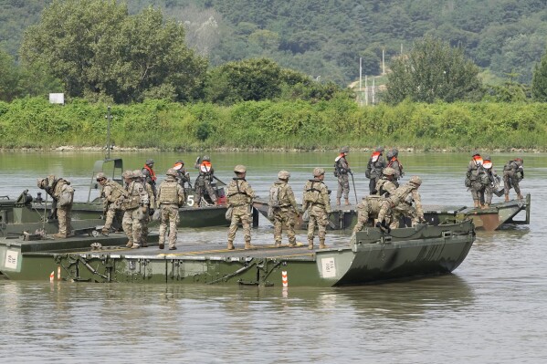 U.S. and South Korean soldiers try to connect a floating bridge during the combined wet gap crossing military drill between South Korea and the United States as a part of the Ulchi Freedom Shield military exercise in Cheorwon, South Korea, on Aug. 31, 2023. (AP Photo/Lee Jin-man)