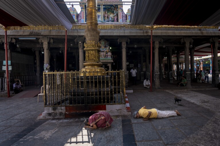 Devotees perform rituals inside Mylapore temple in the southern Indian city of Chennai, April 15, 2024. Southern India is home to some of the country's most visited temples and has millions of Hindu devotees. What sets it apart, experts say, is that religion hasn't been weaponized for political gain. (AP Photo/Altaf Qadri)