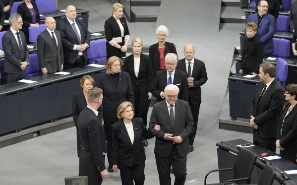German President Frank-Walter Steinmeier leads Holocaust survivor Eva Szepesi to the plenary of the German Bundestag in Berlin, Germany, Wednesday, Jan. 31, 2024. The German parliament remembers the victims of National Socialism at a Ceremony of Remembrance at the Reichstag in Berlin. (AP Photo/Ebrahim Noroozi)