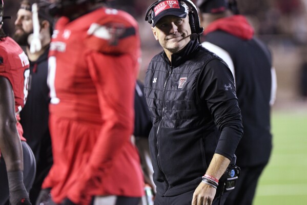 Texas Tech coach Joey McGuire walks along the sideline during the team's NCAA college football game against TCU on Thursday, Nov. 2, 2023, in Lubbock, Texas. (Annie Rice/Lubbock Avalanche-Journal via AP)