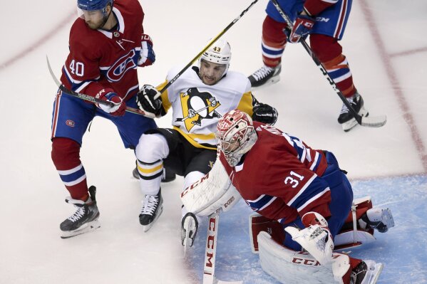 Montreal Canadiens right wing Joel Armia (40) levels Pittsburgh Penguins left wing Conor Sheary (43) in front of Canadiens goaltender Carey Price (31) during the first period of an NHL hockey playoff game Friday, Aug. 7, 2020, in Toronto. (Frank Gunn/The Canadian Press via AP)