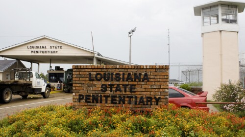 FILE - Vehicles enter at the main security gate at the Louisiana State Penitentiary — the Angola Prison, the largest high-security prison in the country in Angola, La., Aug. 5, 2008. Louisiana officials say they plan to move juveniles currently housed at a temporary lockup in Angola, the country’s largest maximum-security adult prison, to a new youth detention facility by mid-November, 2023.(AP Photo/Judi Bottoni, File)