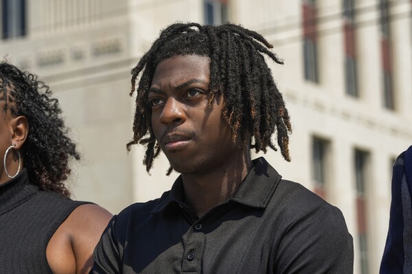 Darryl George, 18, stands next to his mother, Darresha George in front of Galveston County Court House on Thursday, May 23, 2024, in Galveston, Texas. A hearing was set to be held Thursday in a federal lawsuit a George filed against his Texas school district over his punishment for refusing to change his hairstyle. (Raquel Natalicchio/Houston Chronicle via AP)