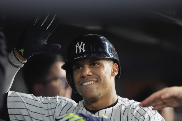 New York Yankees' Juan Soto smiles in the dugout after hitting a home run against the Seattle Mariners during the sixth inning of a baseball game Wednesday, May 22, 2024, in New York. (AP Photo/Frank Franklin II)