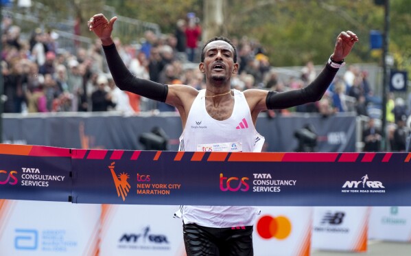 Tamirat Tola, of Ethiopia, crosses the finish line in the professional men's division of the New York City Marathon, Sunday, Nov. 5, 2023, in New York. (AP Photo/Craig Ruttle)