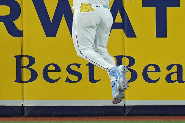 Tampa Bay Rays center fielder Jose Siri (22) makes a leaping catch on a flout by Oakland Athletics' Seth Brown during the eighth inning of a baseball game Friday, April 7, 2023, in St. Petersburg, Fla. (AP Photo/Chris O'Meara)
