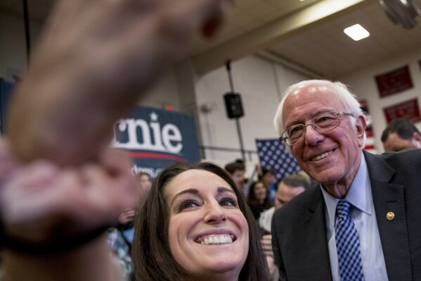 Democratic presidential candidate Sen. Bernie Sanders, I-Vt., takes a photograph with a member of the audience after speaking at a campaign stop at Stevens High School, Sunday, Feb. 9, 2020, in Claremont, N.H. (AP Photo/Andrew Harnik)