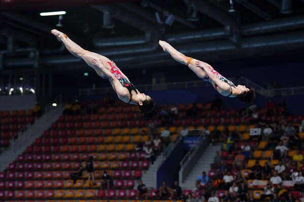 Yani Chang and Yiwen Chen of China compete during the women's synchronized 3m springboard diving final at the World Aquatics Championships in Doha, Qatar, Wednesday, Feb. 7, 2024. (AP Photo/Hassan Ammar)