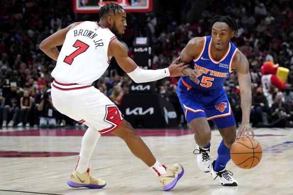 New York Knicks guard Immanuel Quickley, right, drives against Chicago Bulls forward Troy Brown Jr., during the first half of an NBA basketball game Thursday, Oct. 28, 2021, in Chicago. (AP Photo/Nam Y. Huh)