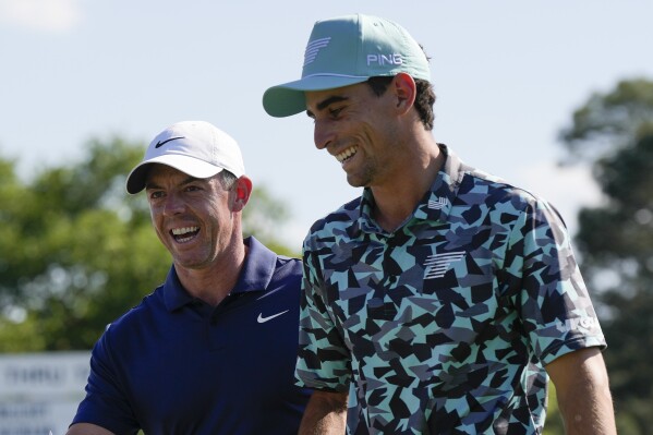 Rory McIlroy, left, of Northern Ireland, and Joaquin Niemann, of Chile, walks off the 18th hole after final round at the Masters golf tournament at Augusta National Golf Club Sunday, April 14, 2024, in Augusta, Ga. (AP Photo/David J. Phillip)