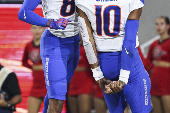 Boise State wide receiver Eric McAlister (80) and quarterback Taylen Green (10) celebrate a touchdown against San Diego State during an NCAA college football game Friday, Sept. 22, 2023, in San Diego. (Meg McLaughlin/The San Diego Union-Tribune via AP)