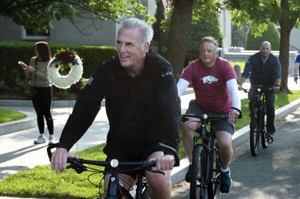 House Speaker Kevin McCarthy, of Calif., leads fellow members of Congress and law enforcement officers as they arrive at the National Law Enforcement Officers Memorial, in Washington, Thursday, May 11, 2023. McCarthy lead his "Back the Blue" bike tour of Washington, before laying wreaths at the memorial. (AP Photo/Cliff Owen)