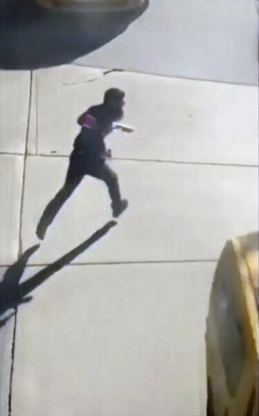 
              This image made from a video provided by Tawhid Kabir shows the suspect in a deadly attack running across the street with a fake gun in each hand on Tuesday, Oct. 31, 2017, in New York. The man mowed down pedestrians and cyclists along a busy bike path near the World Trade Center memorial on Tuesday, before he was shot in the abdomen by police after jumping out of the truck, authorities said. (YouTube/Tawhid Kabir via AP)
            