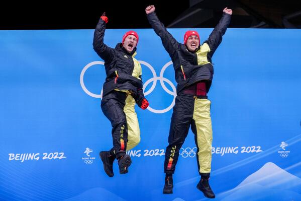 Francesco Friedrich and Thorsten Margis, of Germany, celebrate winning the gold medal in the 2-man at the 2022 Winter Olympics, Tuesday, Feb. 15, 2022, in the Yanqing district of Beijing. (AP Photo/Dmitri Lovetsky)