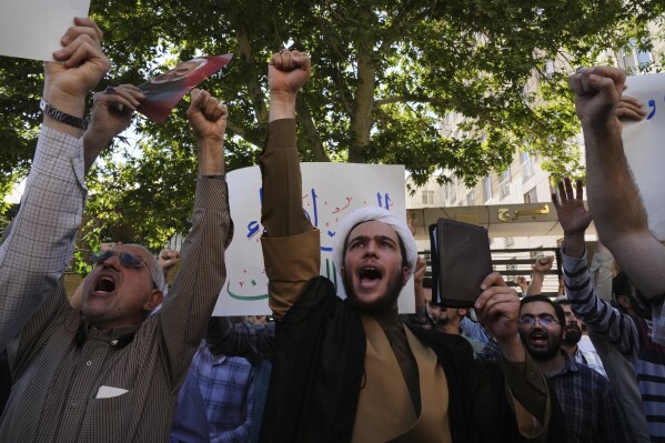 Demonstrators chant slogans during a protest of the burning of a Quran in Sweden, in front of the Swedish Embassy in Tehran, Iran, Friday, June 30, 2023. A Quran burning and a string of requests to approve the destruction of more holy books have left Sweden torn between its commitment to free speech and its respect for religious minorities. The clash of fundamental principles has complicated Sweden's desire to join NATO. (AP Photo/Vahid Salemi)