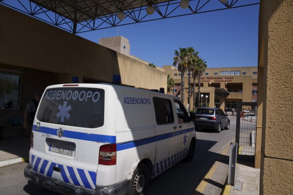 An ambulance drives through the entrance of a state-run hospital on the island of Rhodes, where the body of British TV presenter Michael Mosley was taken following his death while on vacation on the nearby island of Symi, on Monday, June 10, 2024. Family members have traveled to Rhodes to receive the results of an autopsy to establish the cause of death of the 67-year-old presenter.(AP Photo/Petros Giannakouris)