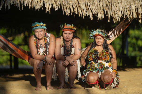 Juma Indigenous sisters Mandei Juma, from left, Mayta Juma and Borea Juma pose for a picture at their community, near Canutama, Amazonas state, Brazil, Sunday, July 9, 2023. The Juma seemed destined to disappear following the death of their father, the last remaining elderly man, but under his three daughters’ leadership, they changed the patriarchal tradition and now fight to preserve their territory and culture. (AP Photo/Andre Penner)